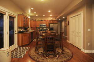 Dining space with dark hardwood / wood-style floors and sink