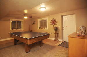 Game room with ceiling fan, carpet, and a textured ceiling