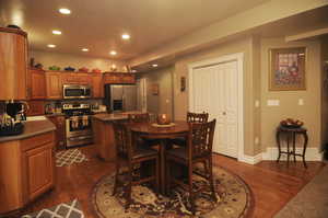 Dining area with dark hardwood / wood-style flooring and sink