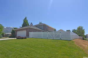 View of yard with a garage and a mountain view