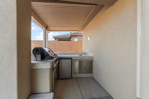 View of patio / terrace featuring a grill, exterior kitchen, and sink