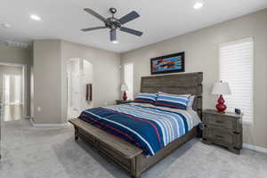 Primary bedroom with ceiling fan and ensuite bathroom