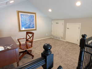 Carpeted loft space featuring vaulted ceiling