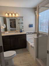 Full bathroom with independent shower and bath, vanity, and toilet