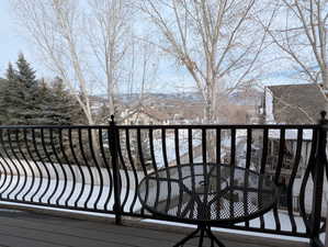 Snow covered back of property with a mountain view