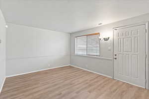 Unfurnished room with light wood-type flooring