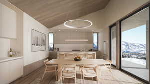 Dining area with high vaulted ceiling, a mountain view, sink, and light wood-type flooring