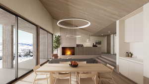 Dining space featuring a towering ceiling, a mountain view, and light wood-type flooring