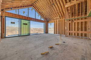 Miscellaneous room featuring a mountain view and high vaulted ceiling