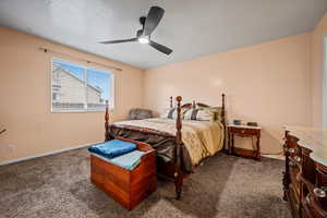 Carpeted bedroom featuring ceiling fan