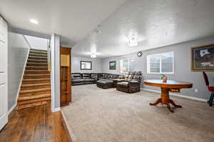 Carpeted living room with a textured ceiling