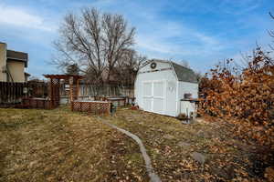 View of yard featuring a storage unit