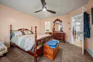 Carpeted bedroom with ceiling fan