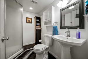 Bathroom with a shower with door and toilet