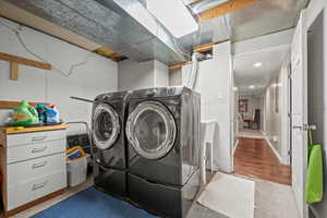 Clothes washing area featuring washing machine and dryer