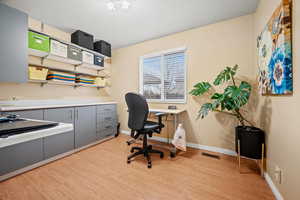 Office space featuring light wood-type flooring