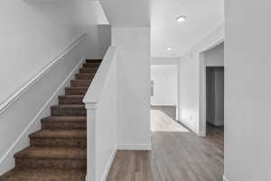 Staircase featuring hardwood / wood-style flooring and a textured ceiling