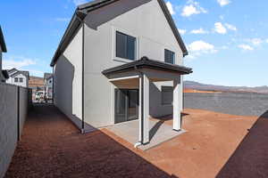 Rear view of house with a patio and a mountain view