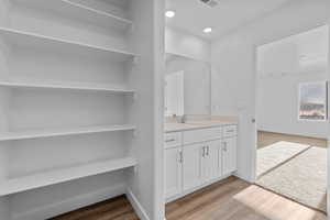 Bathroom with vanity and hardwood / wood-style floors