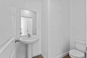 Bathroom featuring wood-type flooring and toilet