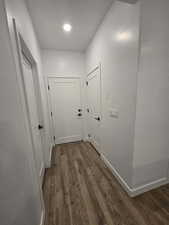 Hall with dark hardwood / wood-style floors