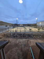 View of yard featuring a mountain view and tennis court