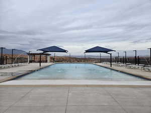 View of swimming pool featuring a mountain view and a patio