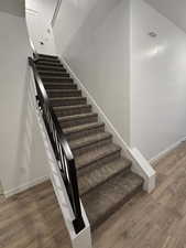 Stairway with hardwood / wood-style flooring