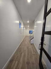 Hallway with wood-type flooring