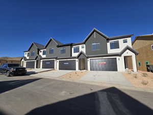 Townhome / multi-family property featuring a garage