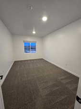 Unfurnished room with carpet floors and a textured ceiling