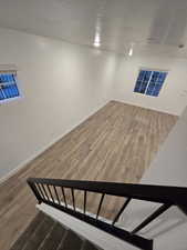 Basement featuring hardwood / wood-style floors and a textured ceiling