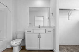 Full bathroom with vanity, bathtub / shower combination, and toilet