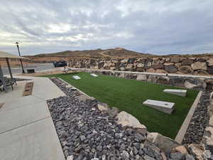 View of yard with a mountain view and a patio area