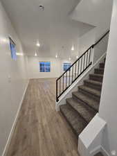 Stairway featuring wood-type flooring