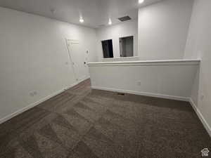 Unfurnished room with dark carpet