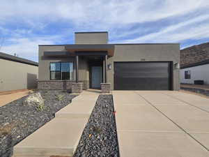 View of front of home with a garage and central AC unit