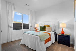 Bedroom featuring dark colored carpet