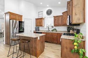 Kitchen with island, gas range, vaulted ceilings, pantry