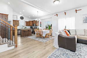 Living room, dining, kitchen with vaulted ceiling