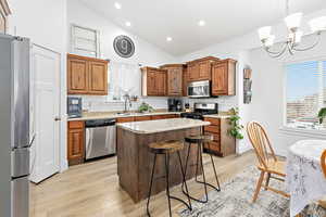 Kitchen with island, gas range, vaulted ceilings, pantry