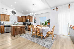 Kitchen, dining area featuring vaulted ceiling