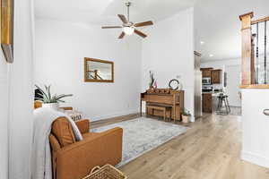 Formal living area with vaulted ceiling, ceiling fan