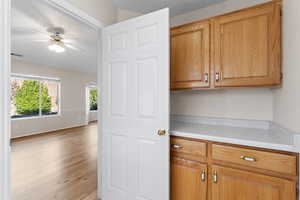 Kitchen with light hardwood / wood-style flooring and ceiling fan