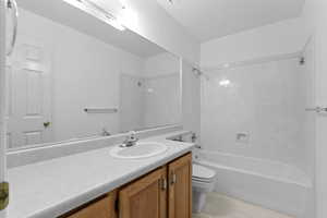 Full bathroom featuring shower / tub combination, vanity, and toilet