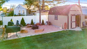 View of yard with a storage unit and a fire pit