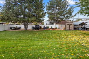 View of yard featuring a storage unit