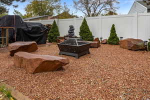 View of yard with an outdoor fire pit