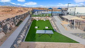 View of community with a mountain view and a lawn