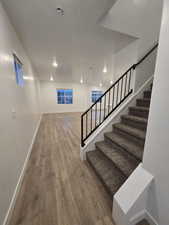 Stairway with hardwood / wood-style flooring